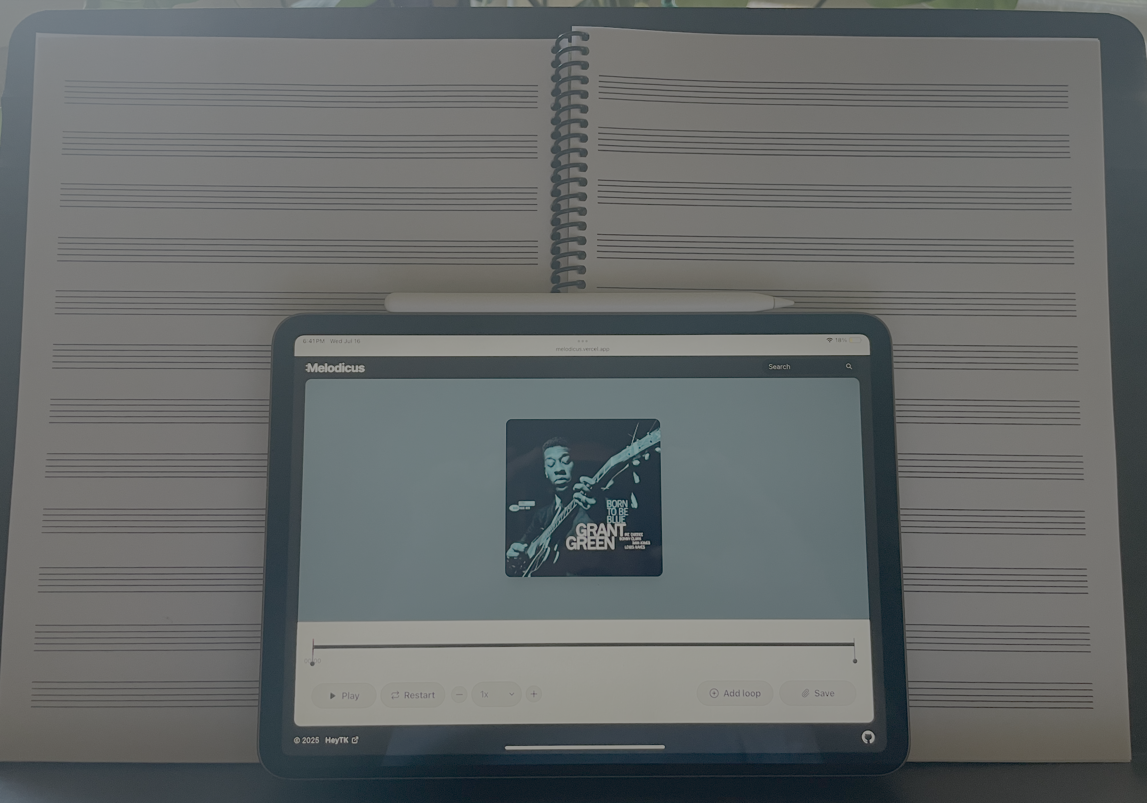 The melodicus application on my ipad on a music stand.